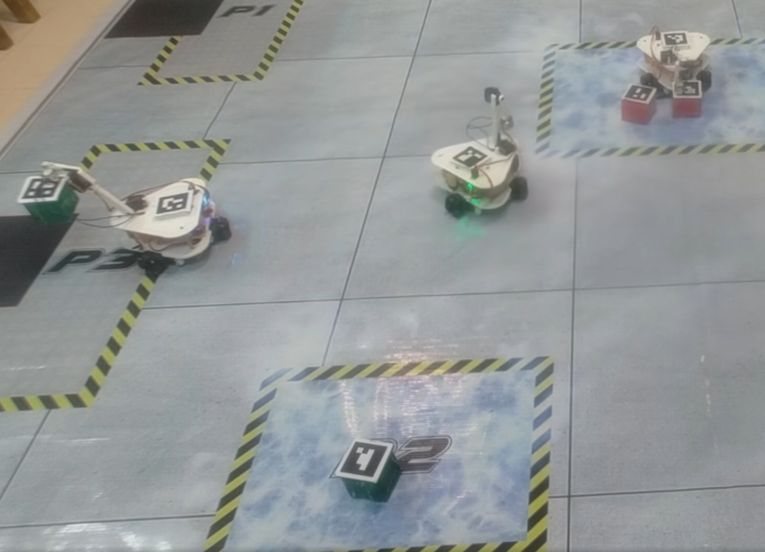 eYRC robotics arena with autonomous robots moving blocks between marked zones